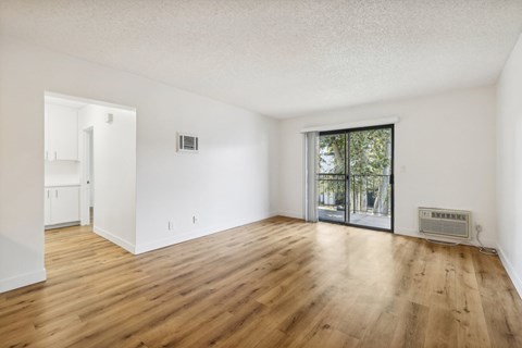 A room with wooden floors and white walls.