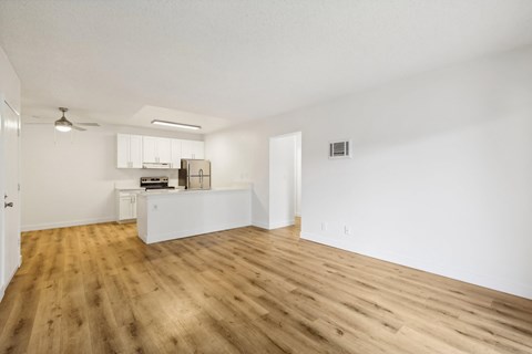 A room with wooden floors and white walls.