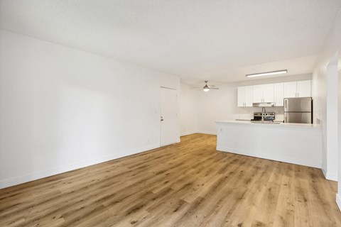 A room with wooden floors and white walls.