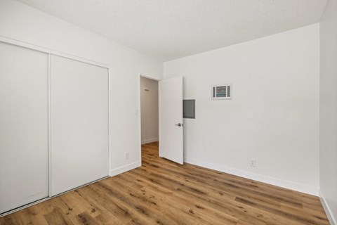 A room with a white door and a white wall.