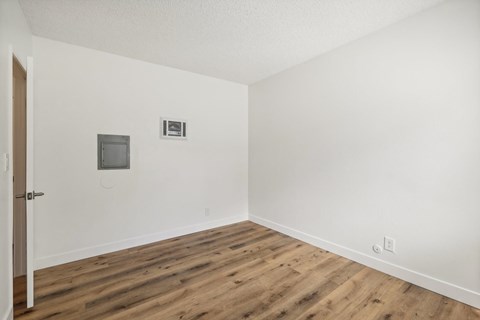 A room with a wooden floor and a door.