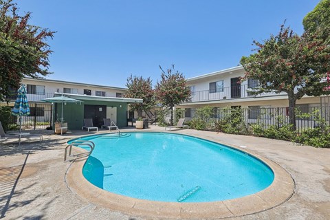 A round above ground pool with a metal fence around it.