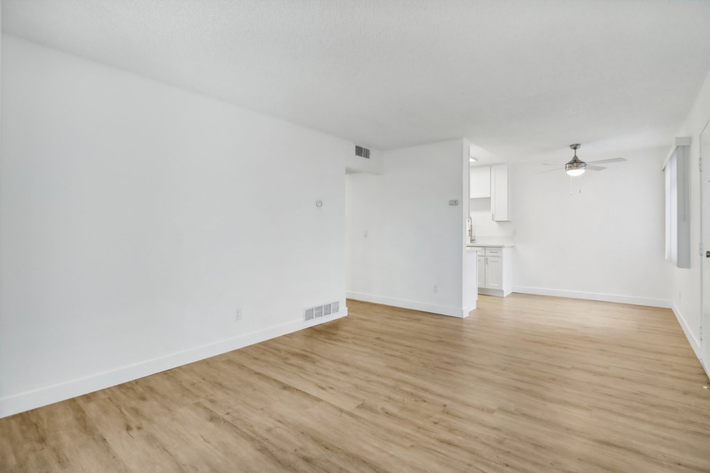 A room with wooden floors and white walls.