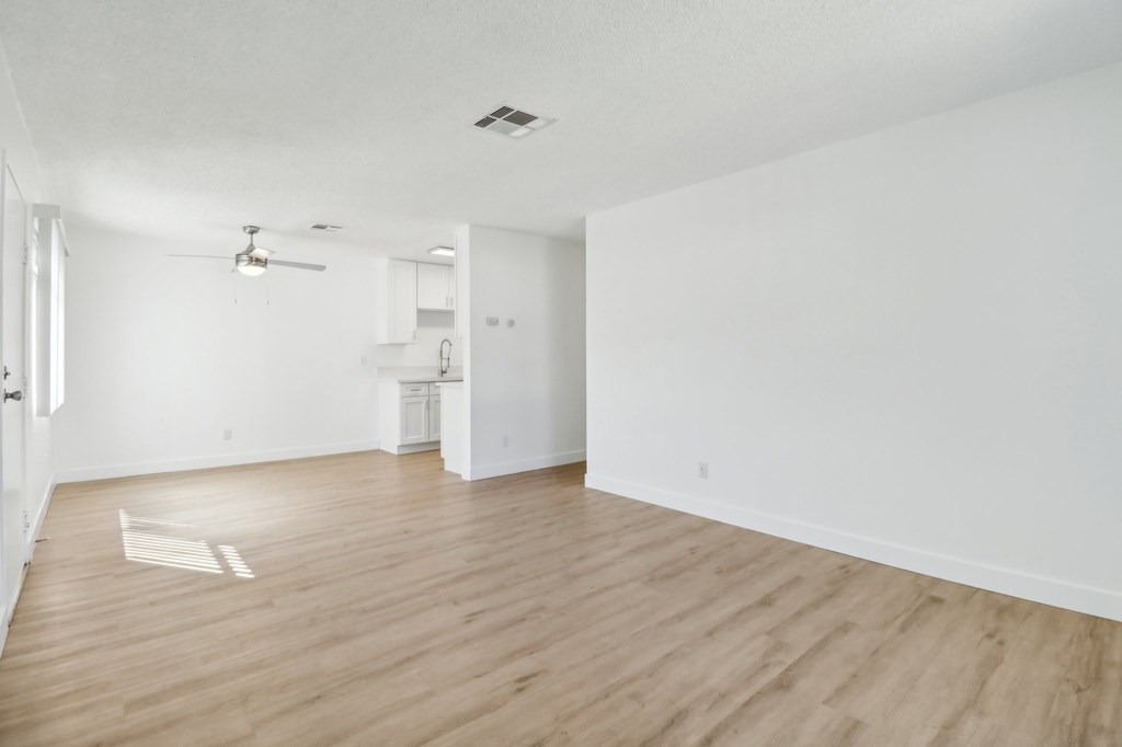 A room with wooden floors and white walls.
