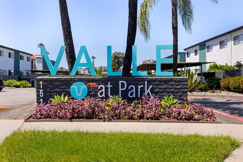 A sign that says "Vallarta Park" in front of some buildings.