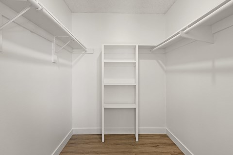 A white shelf in a white room.