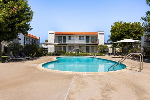 A swimming pool in front of a house.