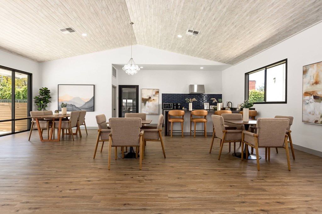 A modern dining room with wooden floors and furniture.
