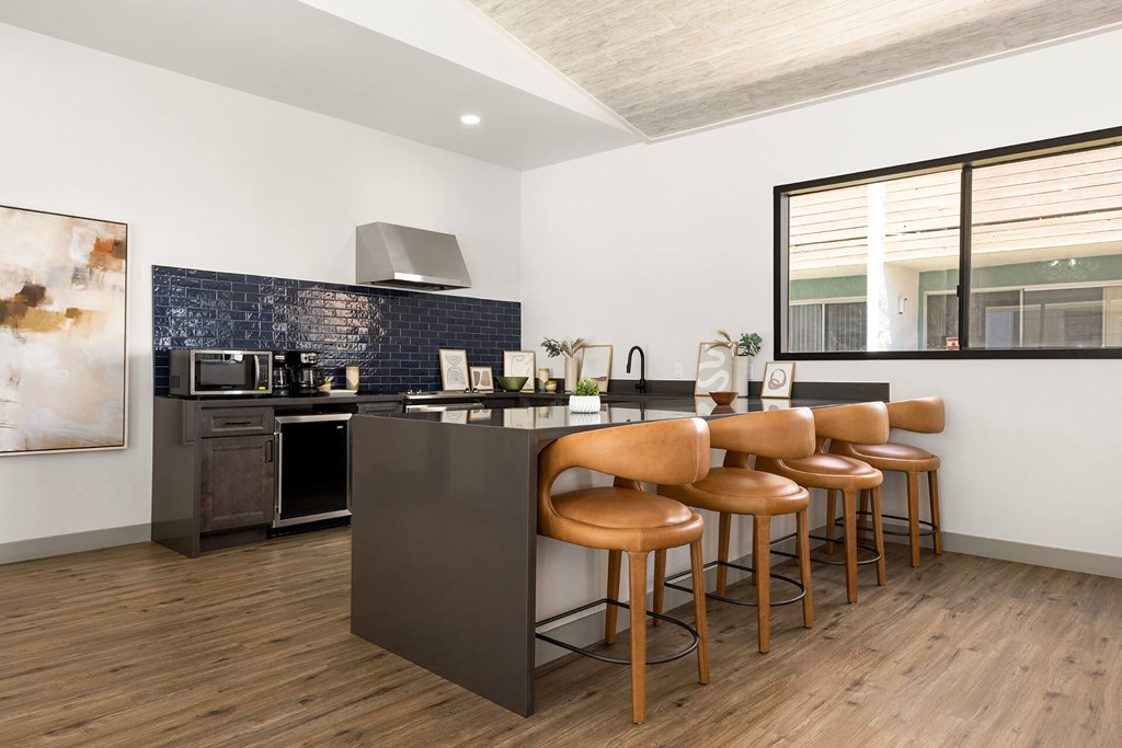 A kitchen with a bar stool and a counter.