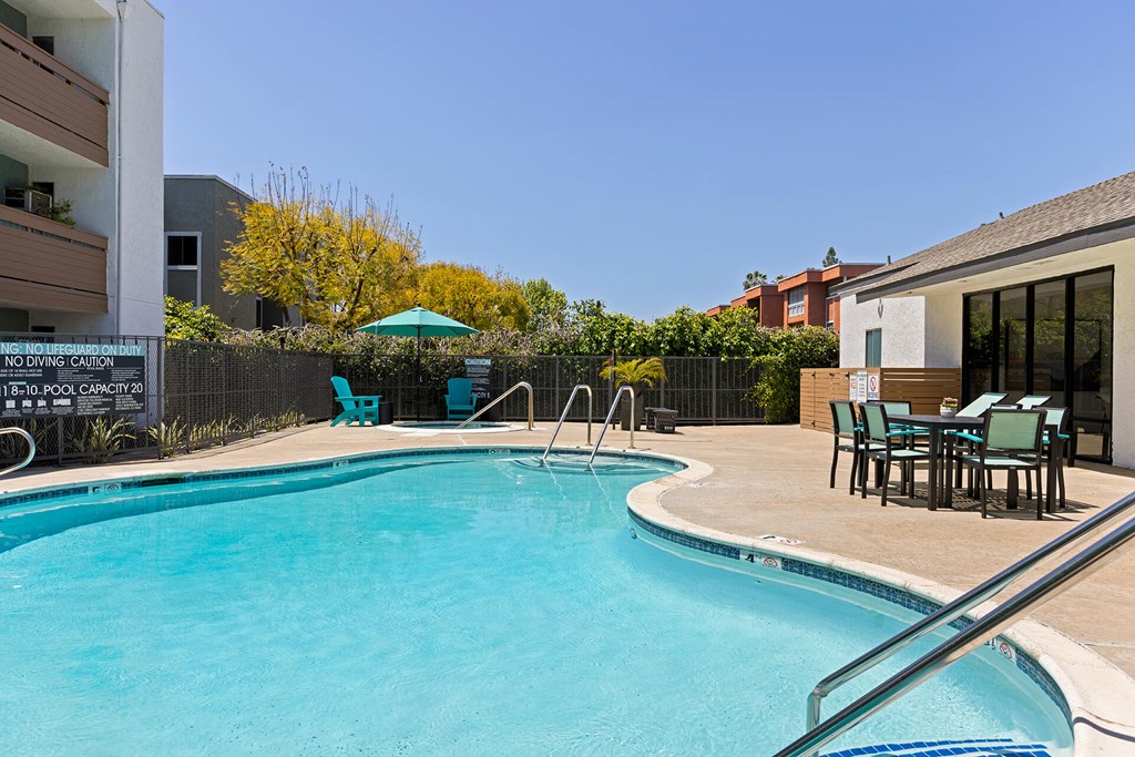 A pool with a no diving sign on the fence.