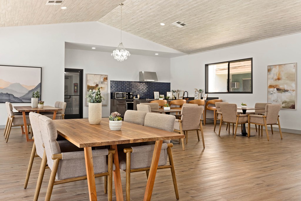 A modern dining room with a wooden table and chairs.