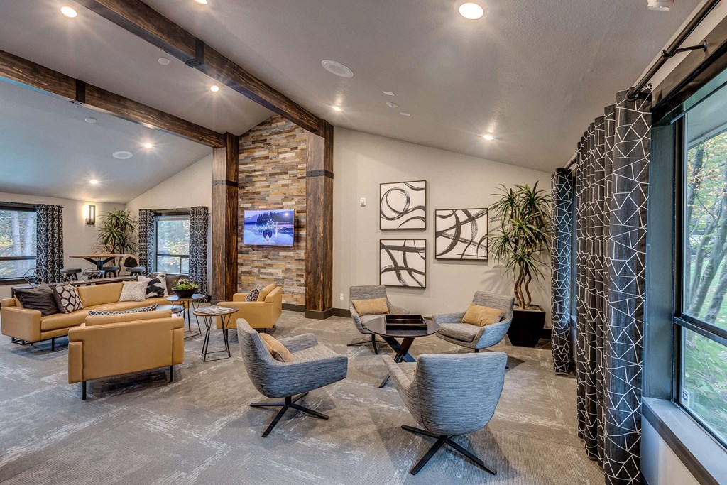 A living room with a stone wall and a large window.