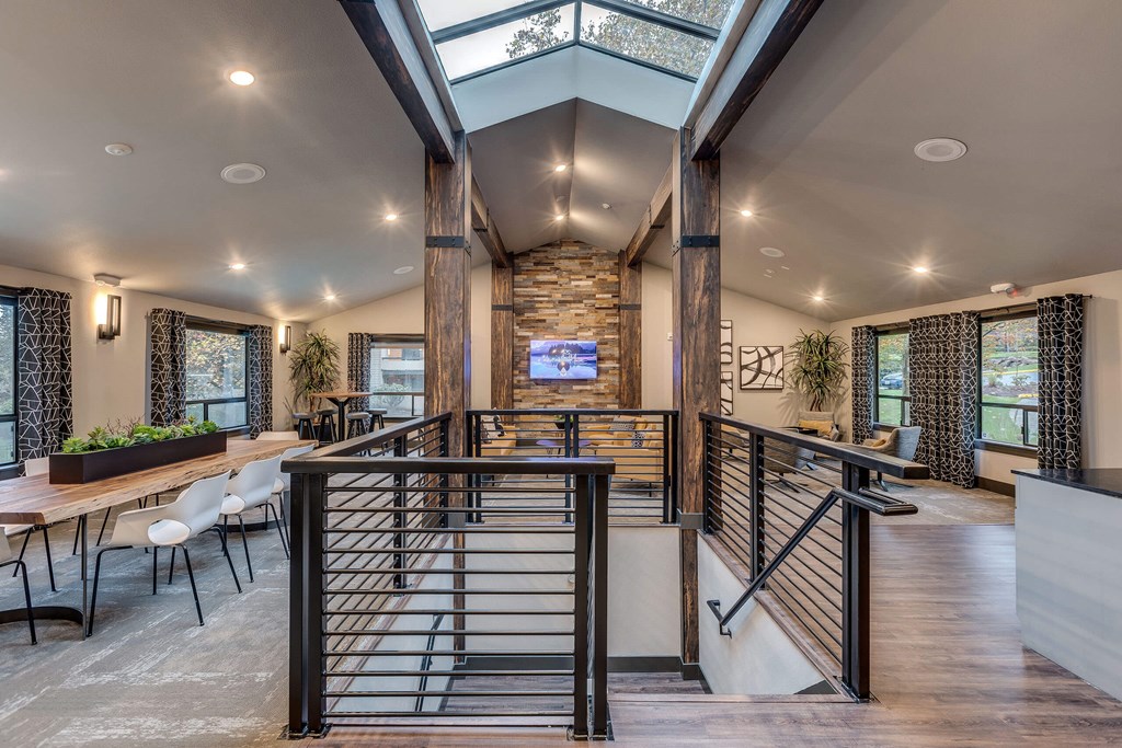 A modern interior with a skylight and a stone pillar.