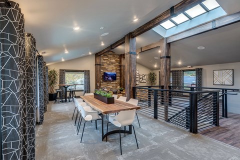 A modern dining room with a wooden table and chairs.