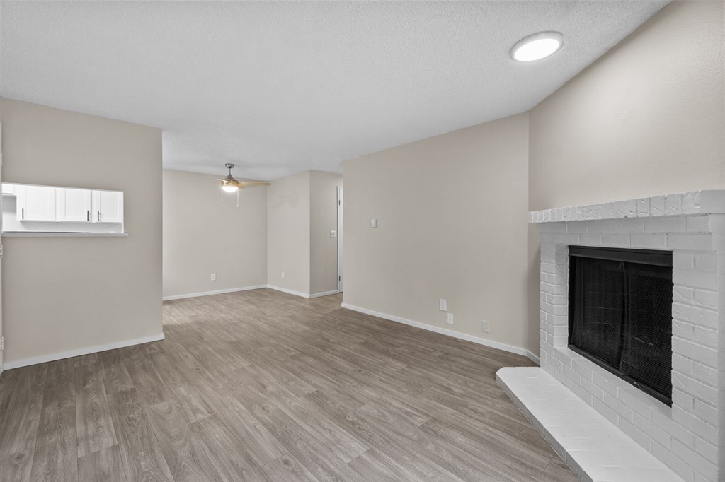 A living room with a fireplace and a window.