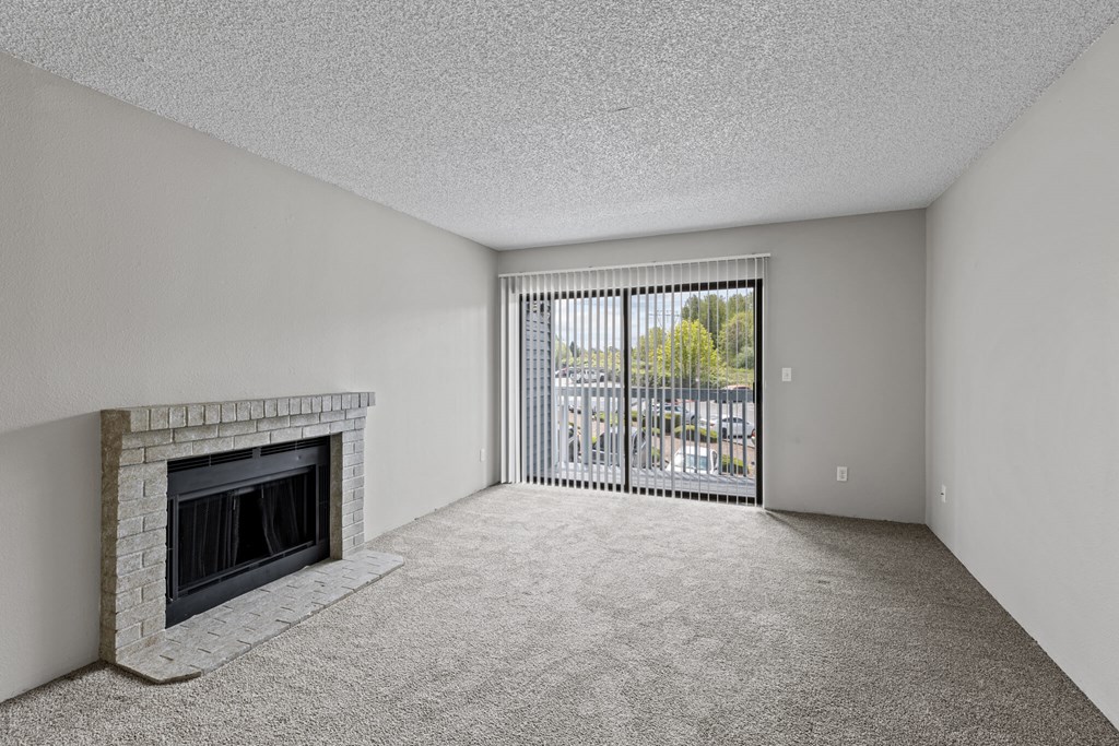 A room with a fireplace and a carpeted floor.