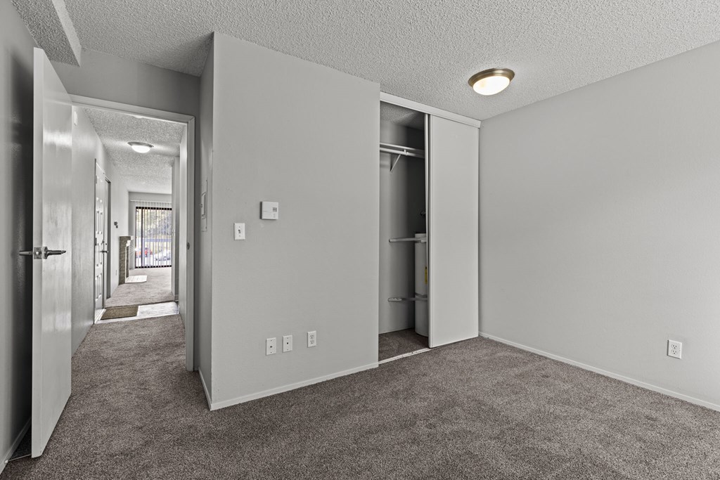 A room with a carpeted floor and white walls.