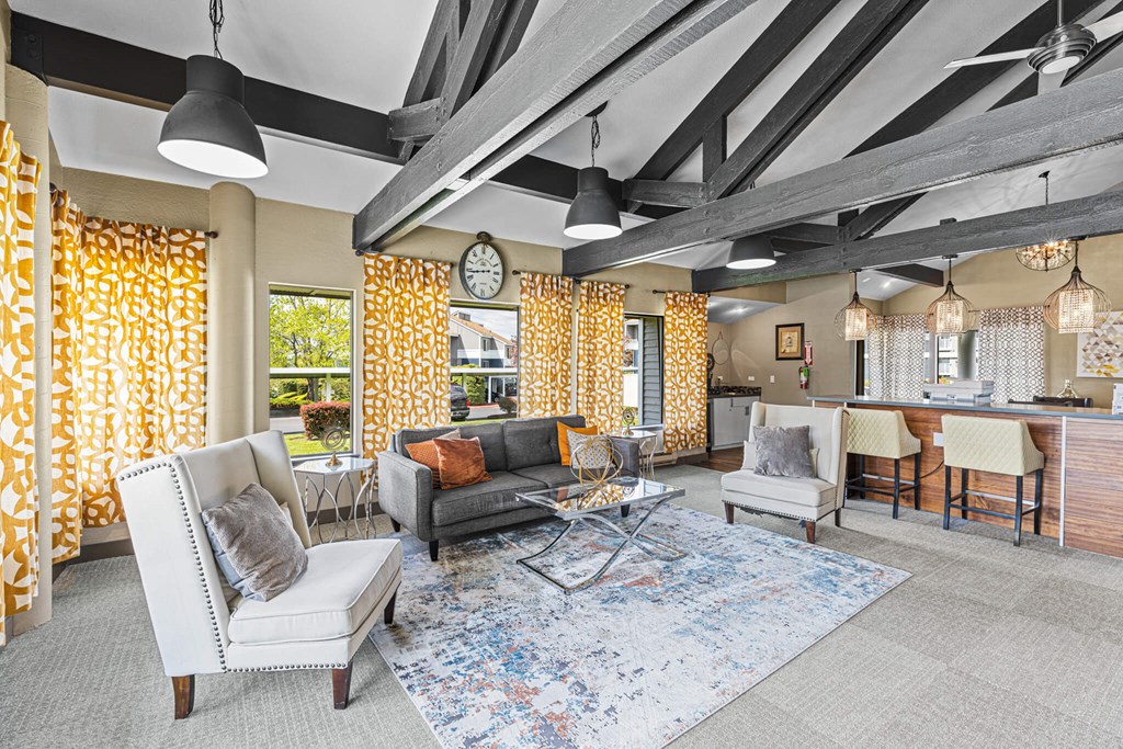 A living room with a grey sofa and a white armchair.