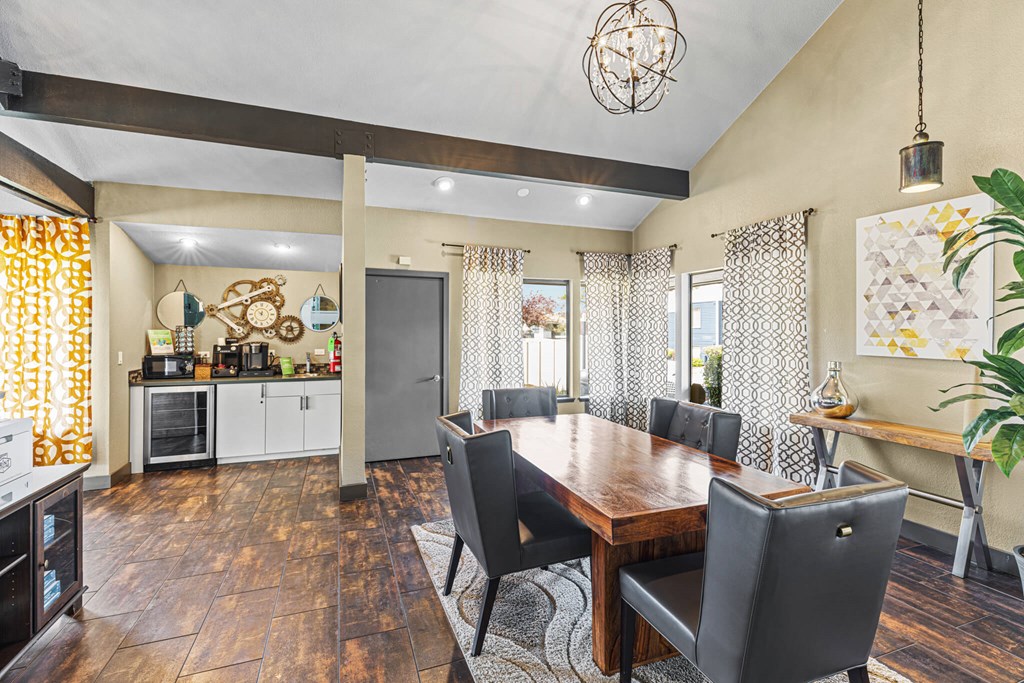 A dining room with a wooden table and chairs.