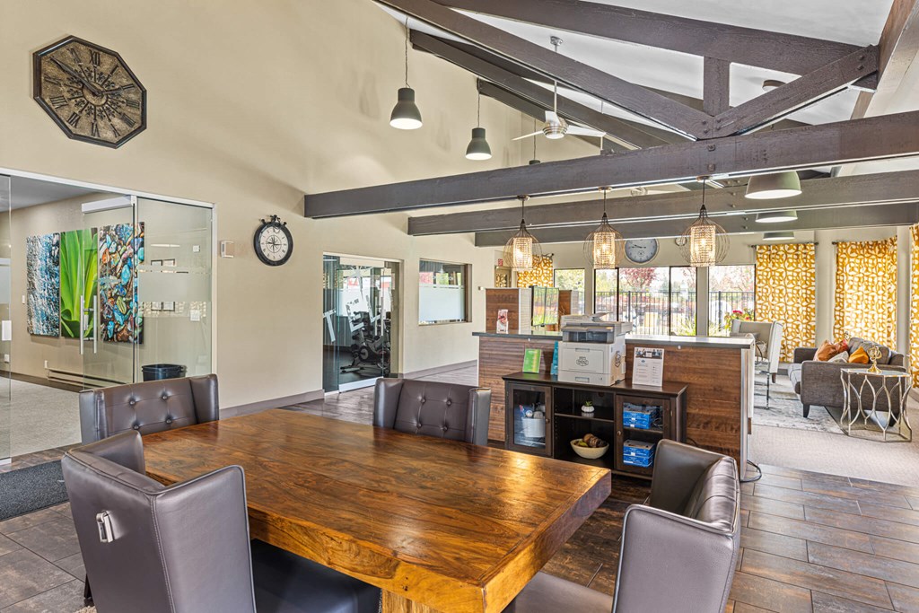 A conference room with a long table and chairs.