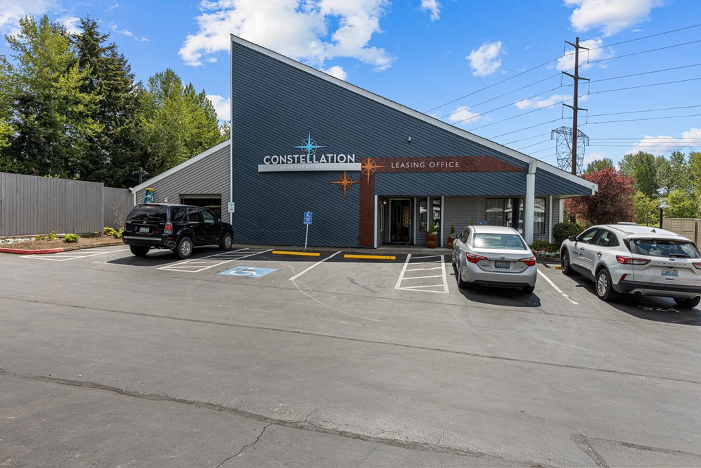 A parking lot in front of a building with the words