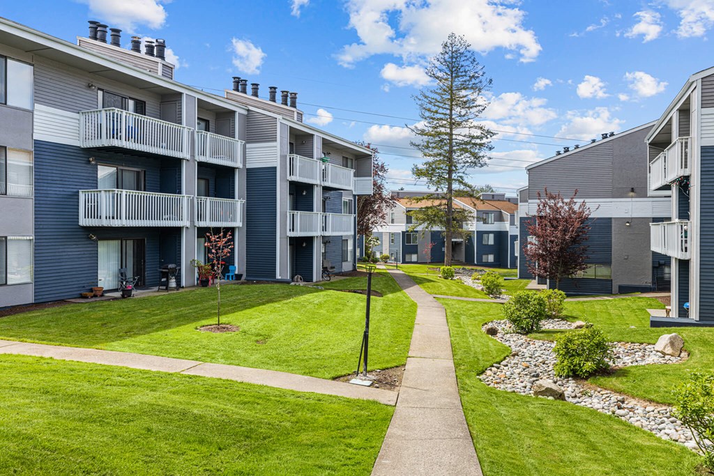Apartment complex with a walkway between the buildings.