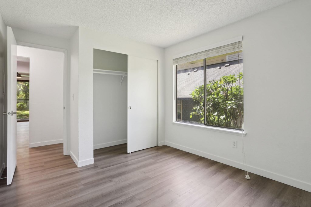 A room with a window and a door.