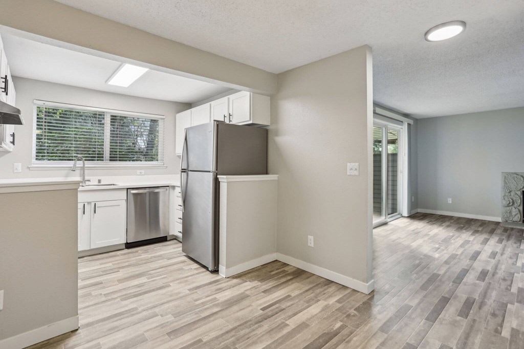 A kitchen with a refrigerator and a dishwasher.