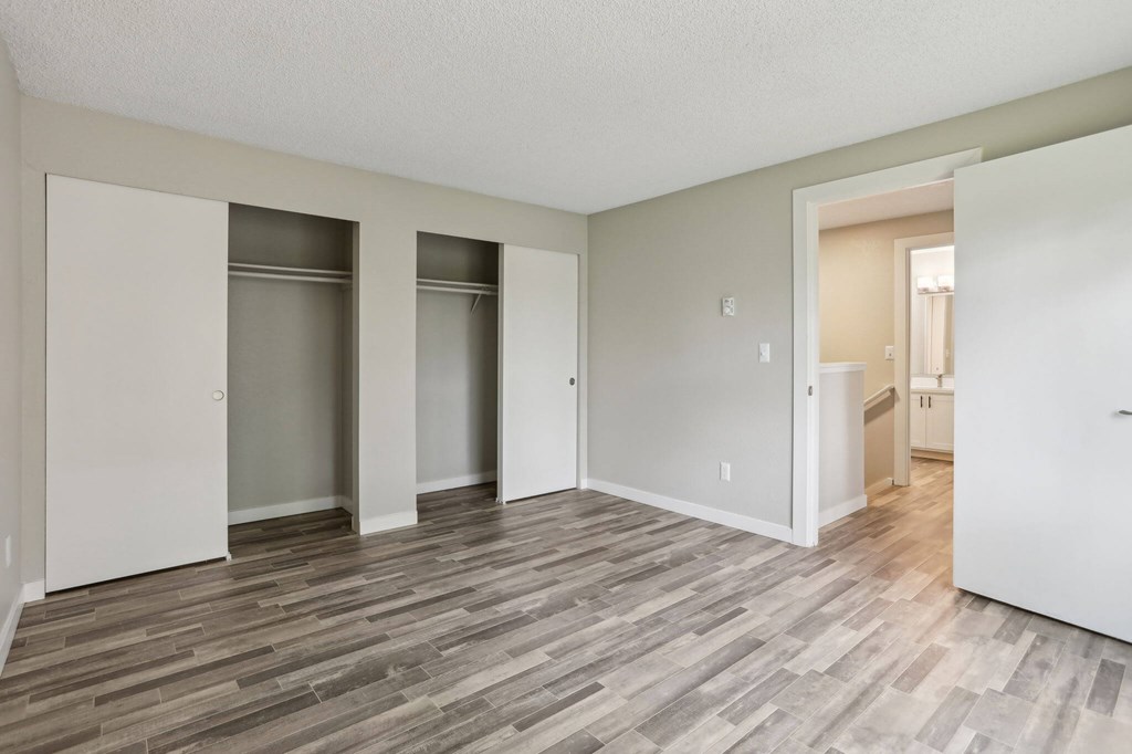 A room with a wooden floor and white walls.