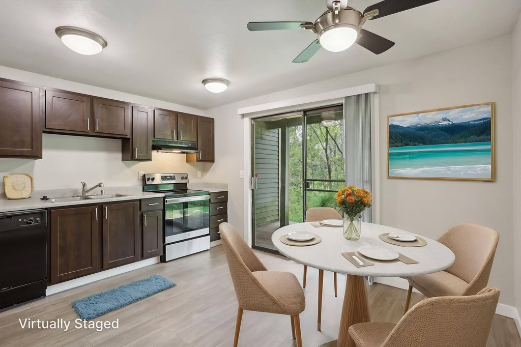 A kitchen with brown cabinets and a dining table set for four.