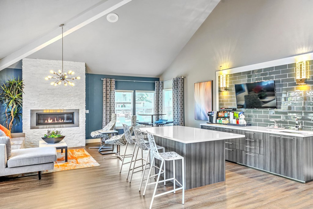 A modern kitchen with a fireplace and a dining area.