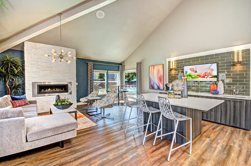 A modern living room with a fireplace and a dining area.