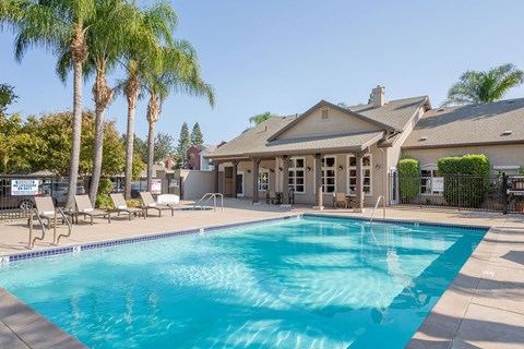 A large house with a pool in front.