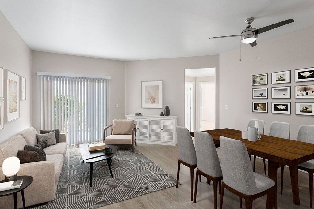 A living room with a couch, chairs, and a dining table.