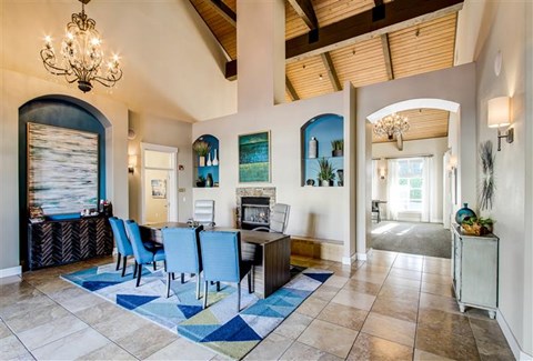 A dining room with a table set for six.