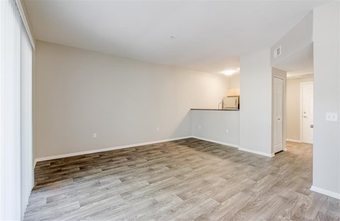 A room with wooden flooring and white walls.
