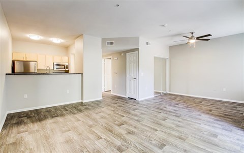 A room with a wooden floor and a ceiling fan.