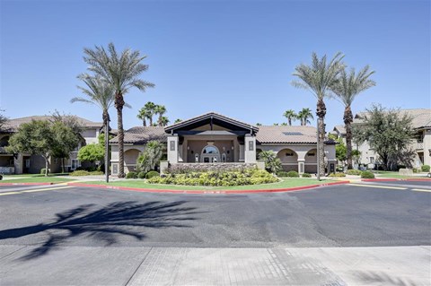 A building with palm trees in front of it.