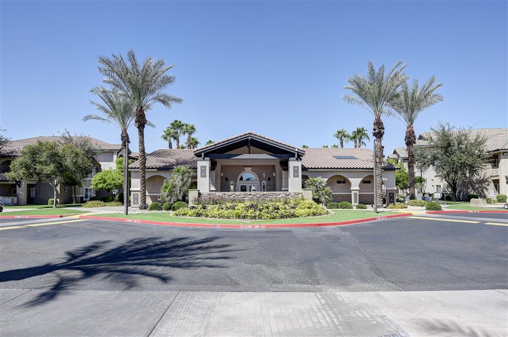 A building with palm trees in front of it.