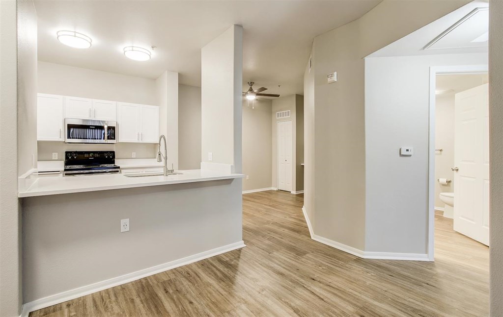 A kitchen area with a counter and a microwave.