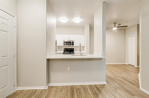 A kitchen area with a microwave, oven, and stove top.