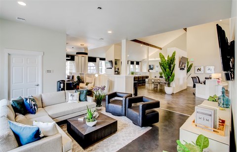 A living room with a white couch and a coffee table.