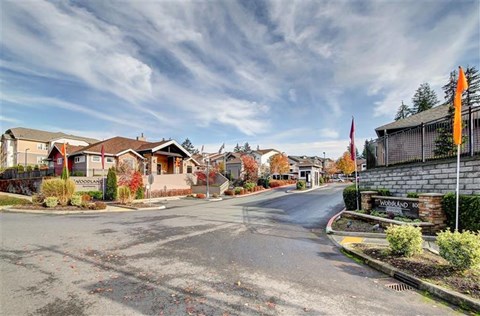A street view of a residential area with houses and a sign that reads "WORLDAN".
