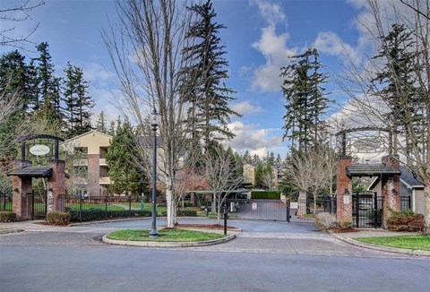 A gated entrance to a residential area with a sign that says "Welcome".