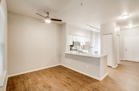 A kitchen area with a counter and a fan.