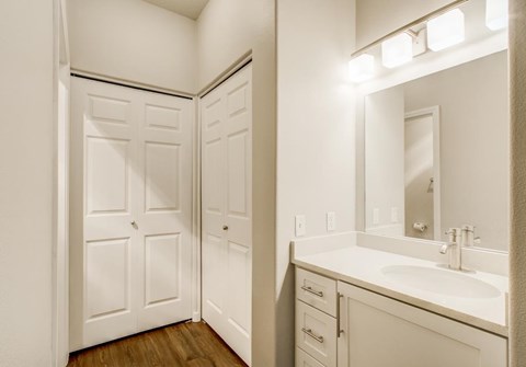 A white bathroom with a sink, mirror, and medicine cabinet.