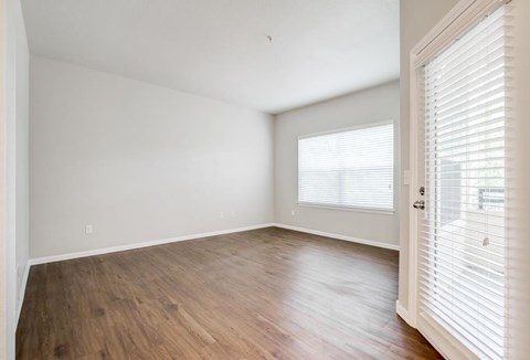 A room with wooden floors and white walls.