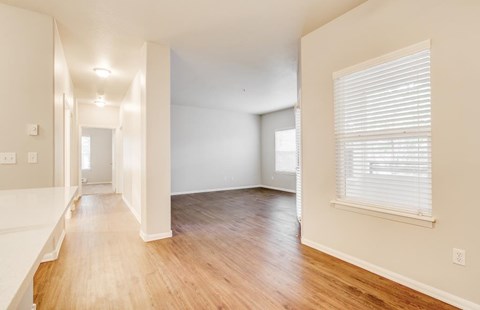 A room with wooden floors and white walls.