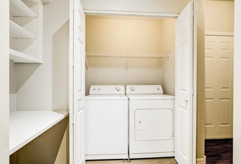 A small laundry room with a washer and dryer.