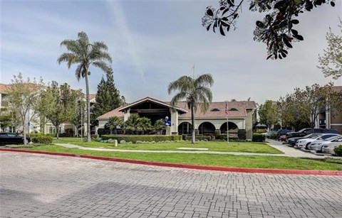A building with a red brick walkway in front of it.